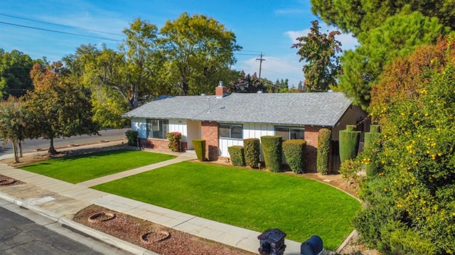 ranch-style home featuring a front yard