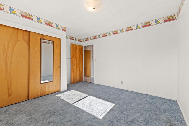 unfurnished bedroom featuring carpet flooring and a closet