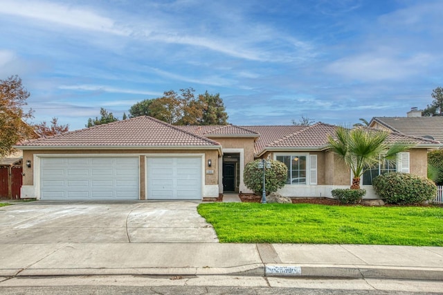 ranch-style house featuring a garage and a front lawn