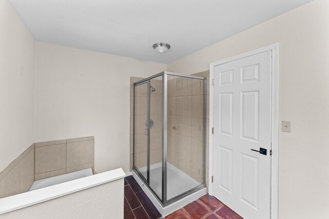 bathroom featuring tile patterned flooring and a shower with door