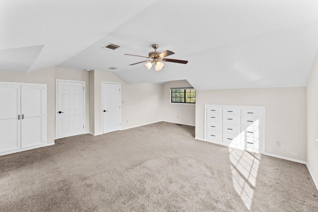 additional living space with carpet floors, vaulted ceiling, and ceiling fan