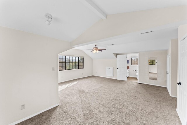 unfurnished living room with lofted ceiling with beams, ceiling fan, and carpet flooring