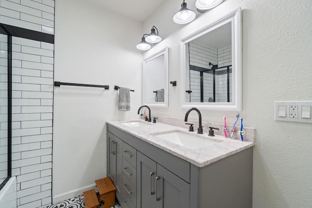 bathroom featuring vanity and tiled shower / bath