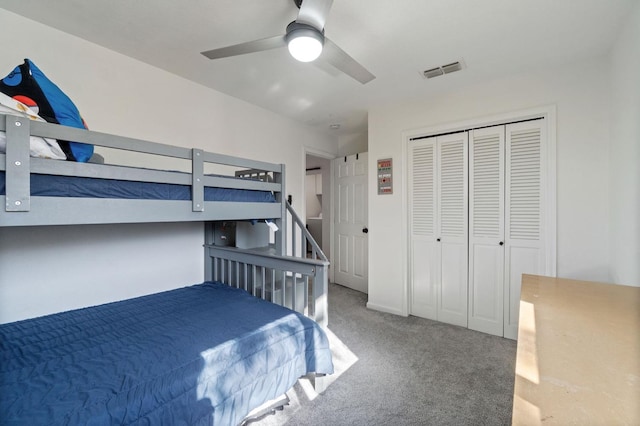 carpeted bedroom featuring ceiling fan and a closet