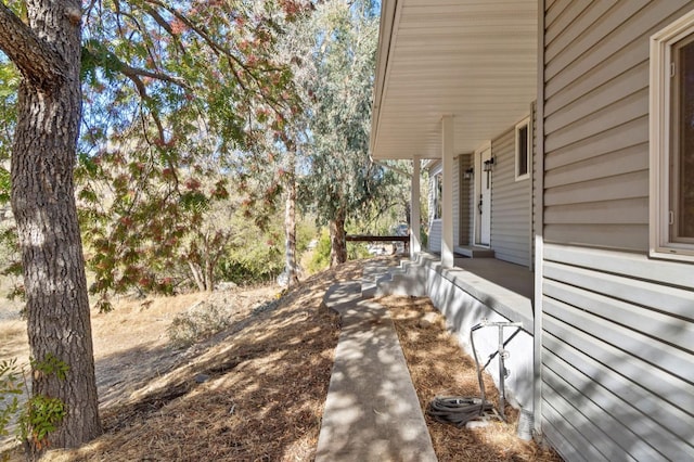 view of side of property with covered porch