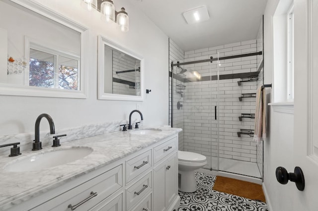 bathroom with vanity, toilet, walk in shower, and tile patterned floors