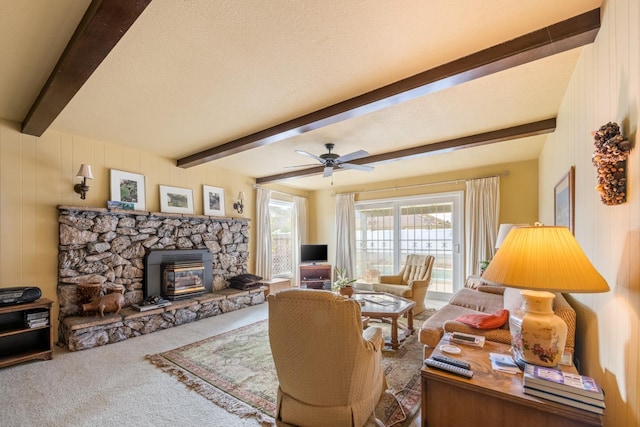 living room with carpet flooring, ceiling fan, beamed ceiling, and a textured ceiling