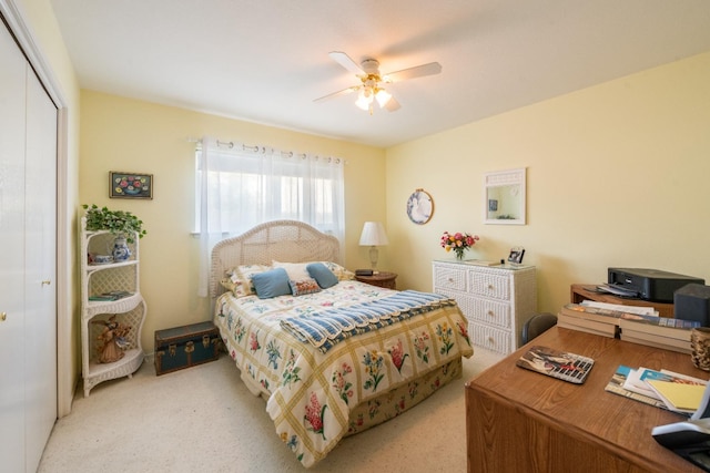 carpeted bedroom featuring ceiling fan and a closet