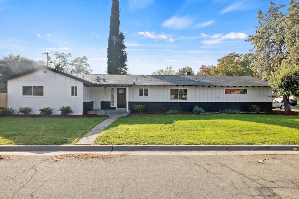 ranch-style house with a front lawn