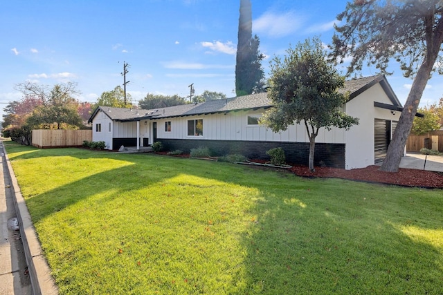 view of front of house featuring a garage and a front lawn