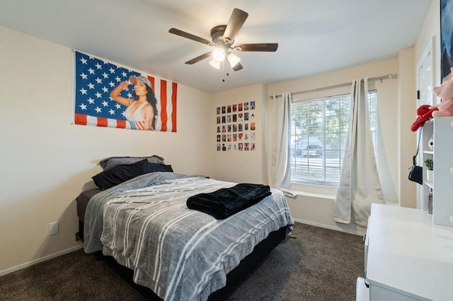 bedroom featuring ceiling fan and dark carpet