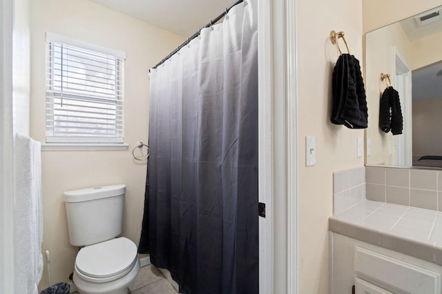 bathroom featuring tile patterned flooring and toilet