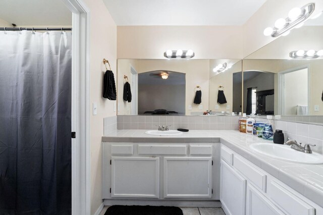 bathroom featuring backsplash, tile patterned floors, and vanity