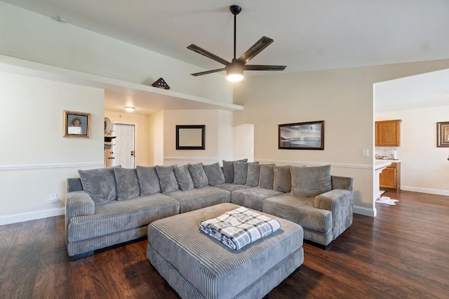 living room with ceiling fan, dark hardwood / wood-style flooring, and vaulted ceiling