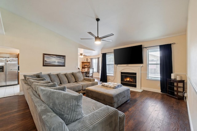 living room featuring ceiling fan, high vaulted ceiling, and dark hardwood / wood-style floors