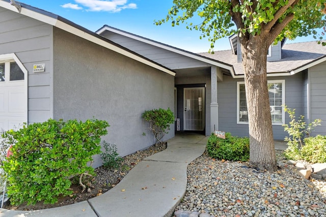 view of exterior entry with a garage