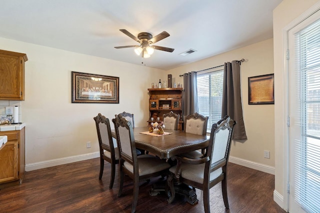 dining space featuring ceiling fan and dark wood-type flooring