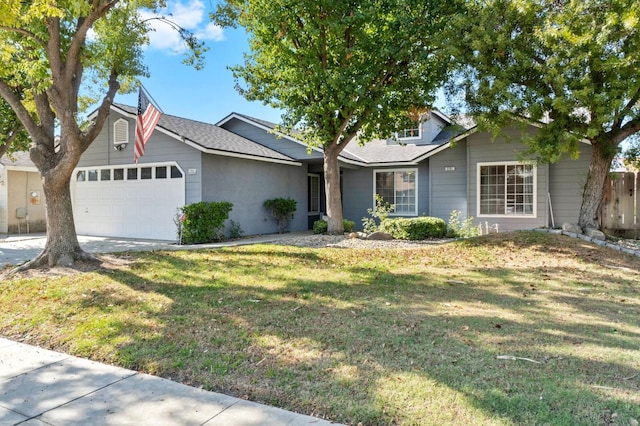 ranch-style house featuring a garage and a front lawn