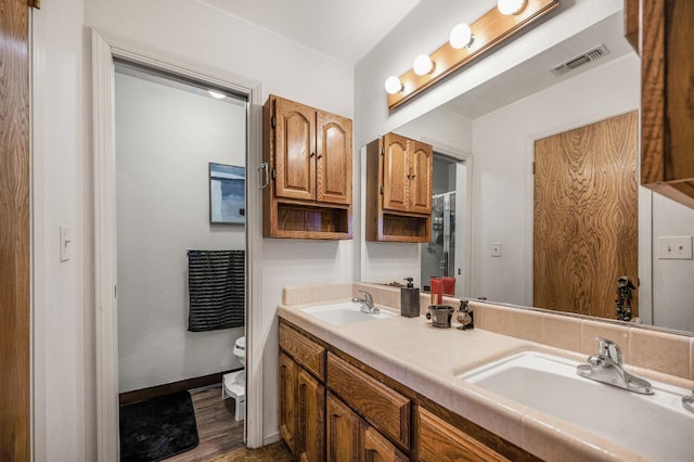 bathroom featuring hardwood / wood-style floors, vanity, and toilet