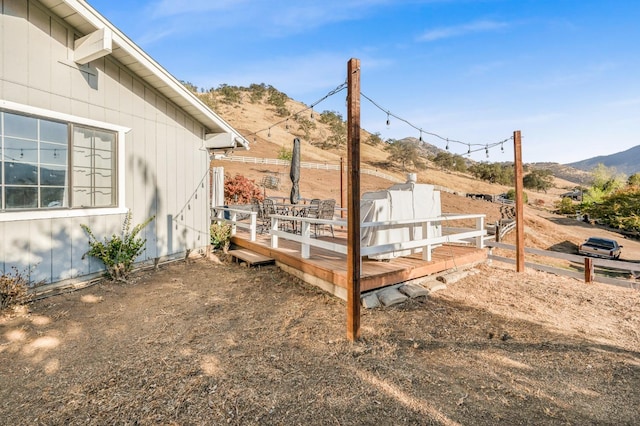 view of yard featuring a deck with mountain view