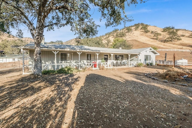 view of front of property featuring a mountain view and a porch