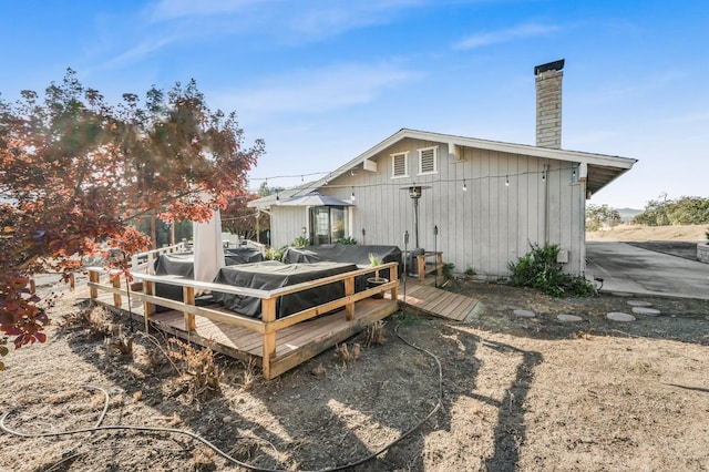 back of property featuring a wooden deck