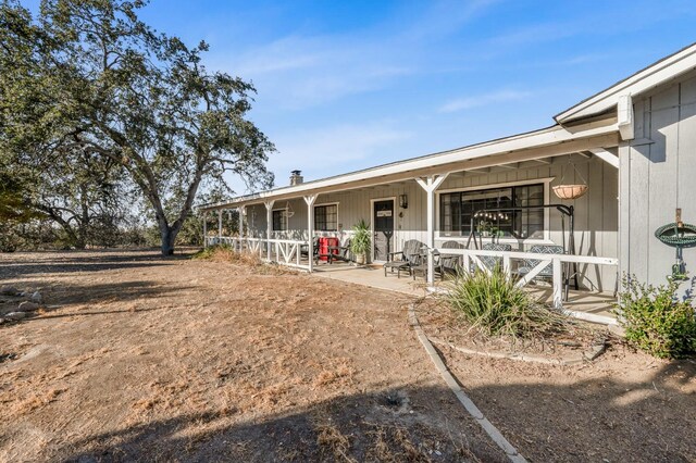 back of house featuring covered porch