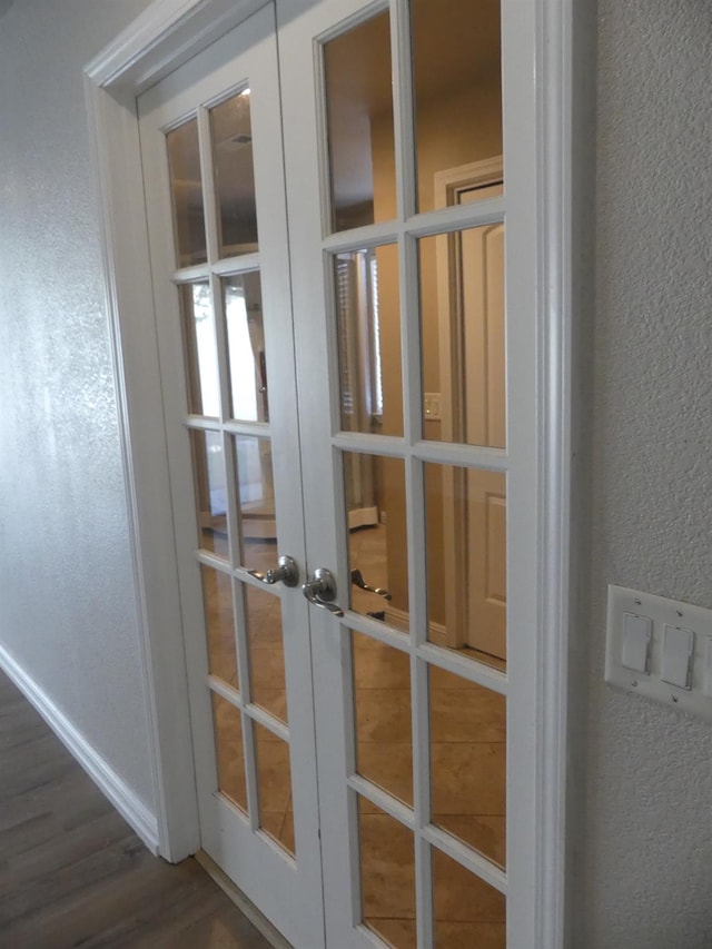 details featuring french doors and hardwood / wood-style flooring