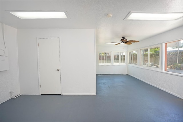 interior space with ceiling fan and a textured ceiling