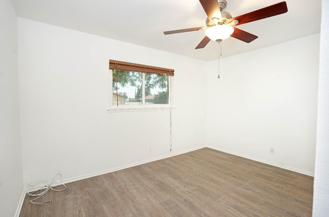 unfurnished room featuring hardwood / wood-style floors and ceiling fan