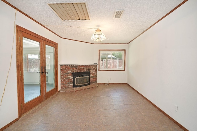 unfurnished living room featuring a chandelier, french doors, a textured ceiling, and crown molding