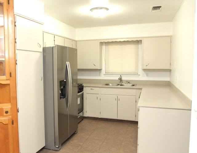 kitchen featuring white cabinets, stainless steel appliances, and sink