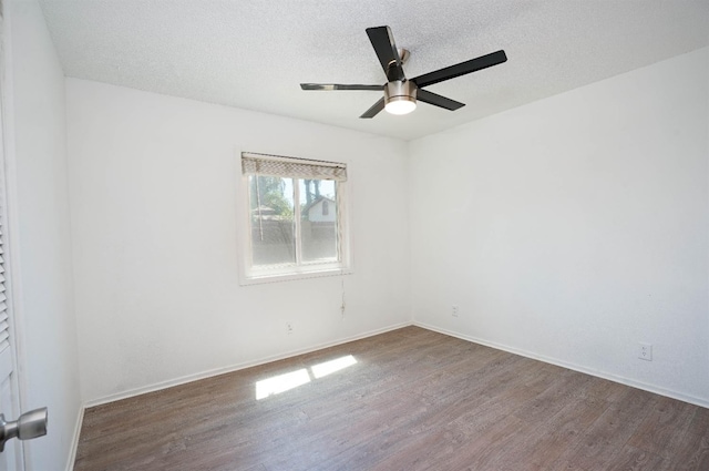 empty room with hardwood / wood-style floors, ceiling fan, and a textured ceiling