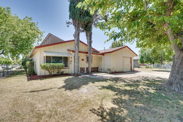 view of front of property with a front yard and a garage