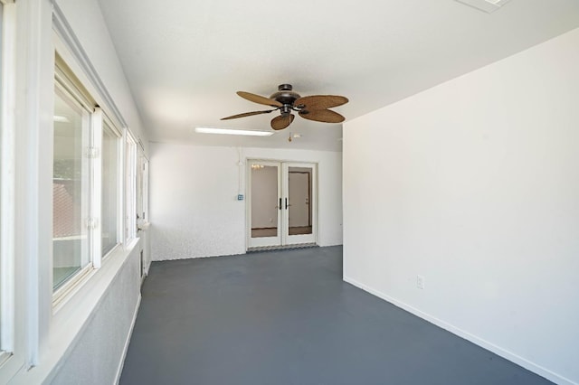 spare room featuring french doors and ceiling fan