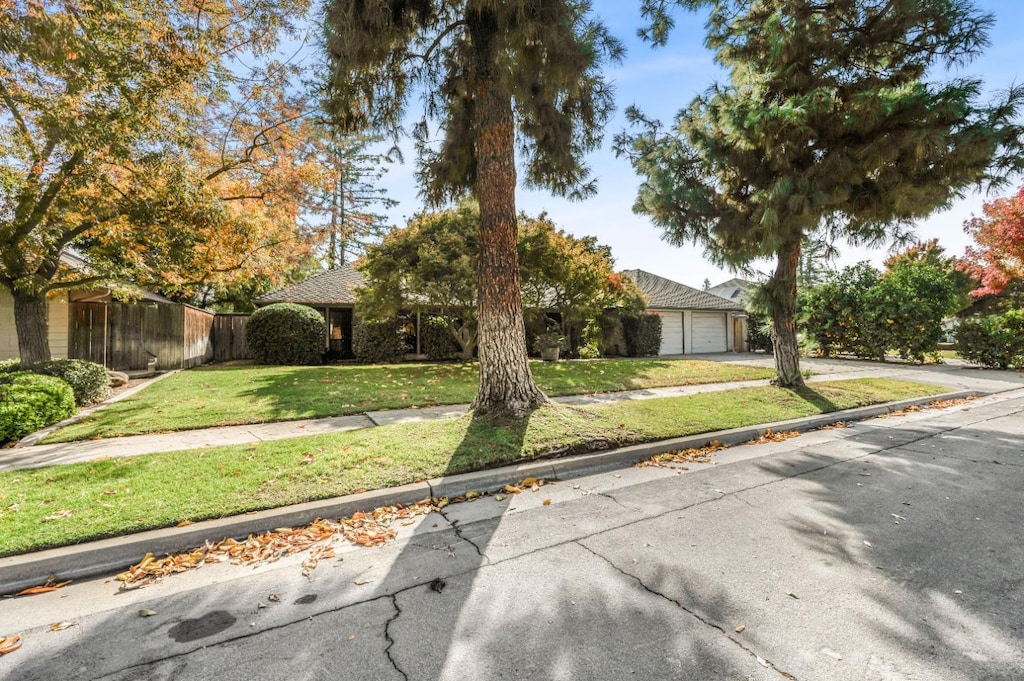 view of front of home with a front yard and a garage