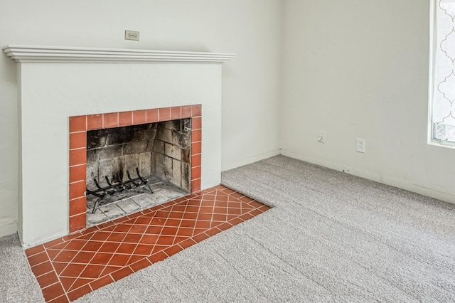 details featuring a tile fireplace and carpet floors