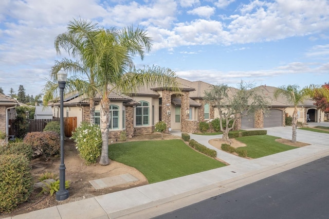 mediterranean / spanish-style home featuring a garage and a front yard