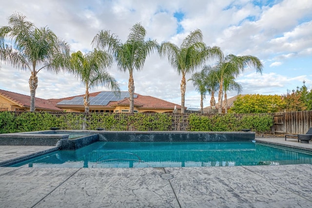 view of swimming pool featuring an in ground hot tub