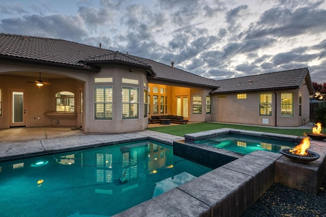 view of pool featuring a fire pit, an in ground hot tub, and a patio