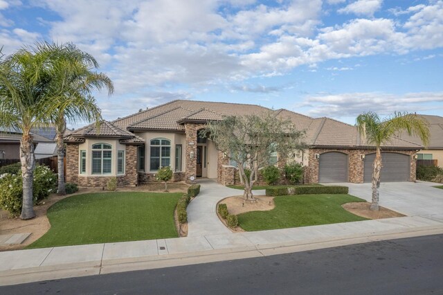 view of front of house featuring a garage and a front yard