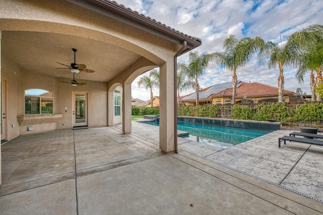 view of pool with ceiling fan and a patio