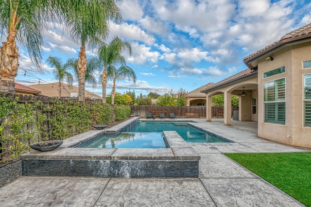 view of pool with an in ground hot tub