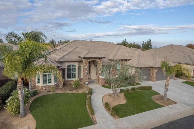 view of front of home featuring a garage and a front yard