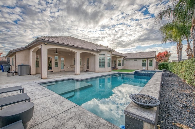 view of swimming pool with an in ground hot tub, ceiling fan, a patio, and central AC unit