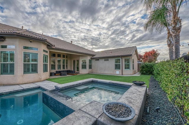 view of pool featuring a lawn, an outdoor living space, and an in ground hot tub