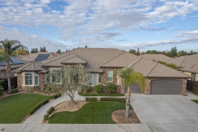 view of front of house featuring a front lawn and a garage