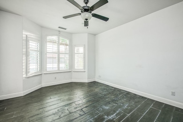 spare room featuring ceiling fan and dark hardwood / wood-style flooring