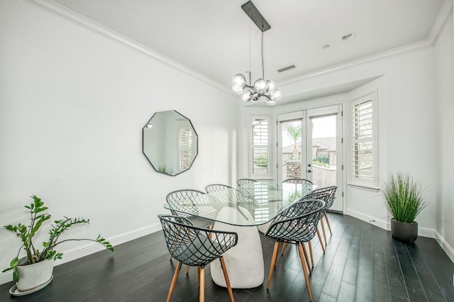 dining space with dark hardwood / wood-style floors, ornamental molding, and a notable chandelier