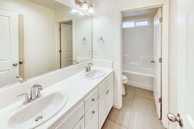 bathroom featuring tile patterned flooring, vanity, and toilet